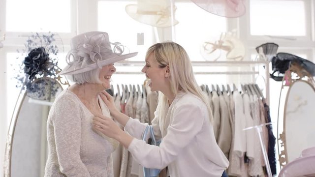  Woman takes a photo of her grandmother while shopping in a bridal wear store