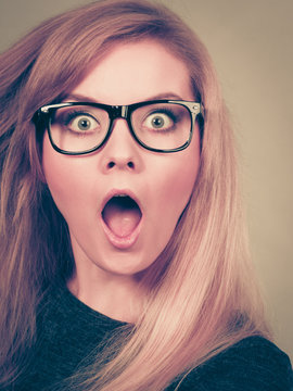 Woman in eyeglasses having shocked face expression