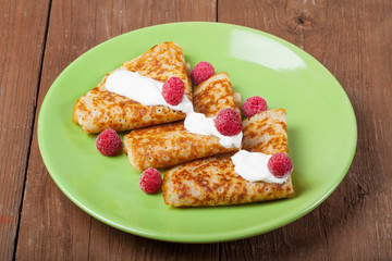 Russian pancakes - blini with sour cream topping. Selective focus