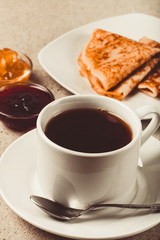Cup of tea with jam, sour cream and russian pancakes - blini. Toned