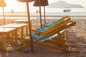 Beach chairs and umbrella on  ocean beach in morning.
