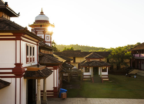 temple in Goa, India and beautiful sunset throuth the roof