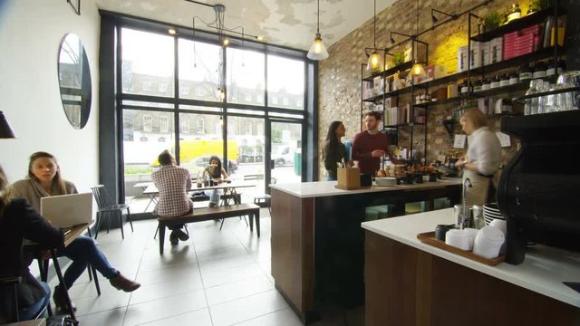  Time lapse of customers & staff in small, busy coffee shop. Shot on RED Epic.