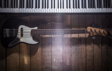piano and guitar on wooden background closeup