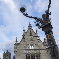 Fototapeta na wymiar Medieval downtown and light post in Ghent, Belgium, in a sunny day in the beginning of spring