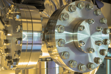 Detail of vacuum equipment with steel flanges bolted to the vessel in laboratory or industrial environment. 