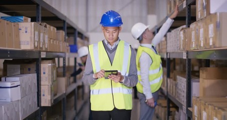  Time lapse of busy workers in industrial warehouse - Powered by Adobe