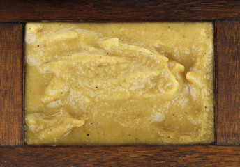mustard in wooden box isolated