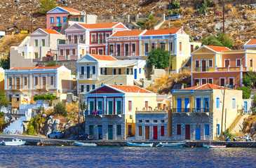 Greece. Dodecanesse. Island Symi Simi . Colorful houses on rocks