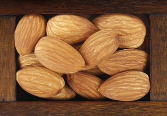 Obraz na płótnie Canvas almonds in wooden box isolated