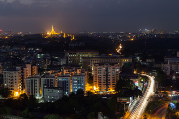 View of Yangon, Myanmar, from above in the evening. Lit Shwedagon Pagoda is in the distant.