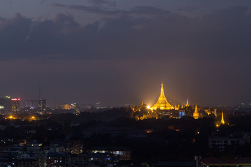 View of lit and golden Shwedagon Pagoda on a hill in Yangon, Myanmar, in the evening. Copy space. © tuomaslehtinen