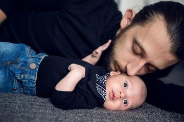 father and son lying on the bed