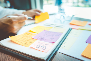 Blur businessman working with note paper for brainstorming ideas.strategy marketing planning...