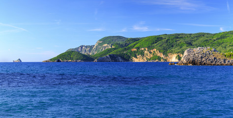Fototapeta na wymiar Beautiful summer panoramic seascape. View of the coastline into the sea bays with crystal clear azure water. Paleokastrica. Corfu. Greece.