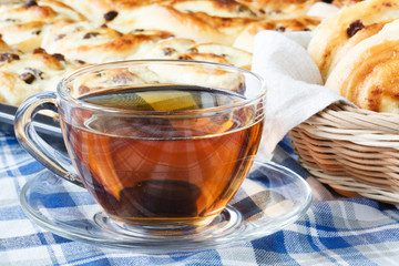 Tasty croissants and cup of coffee on table close-up