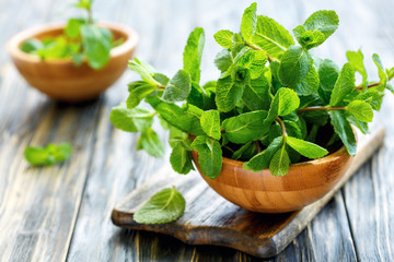 Mint leaves in wooden bowls.