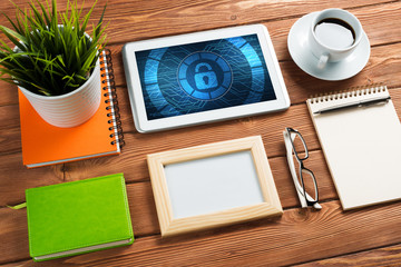 Web security and technology concept with tablet pc on wooden table