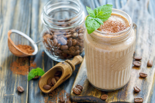 Coffee smoothie with banana in a glass jar.