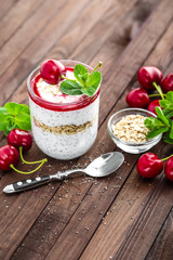 Fresh cherry yogurt with oats and chia seeds, delicious dessert for healthy breakfast