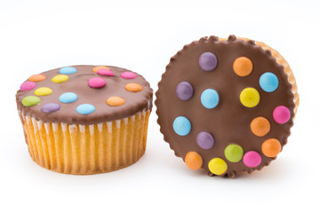Multiple colorful decorated muffins on a white background.