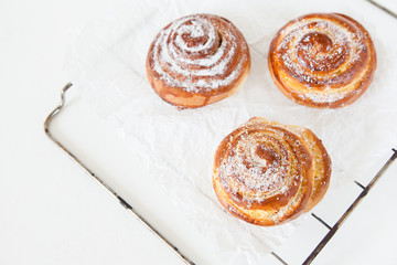 Sweet rolls with sugar and cinnamon on white background.