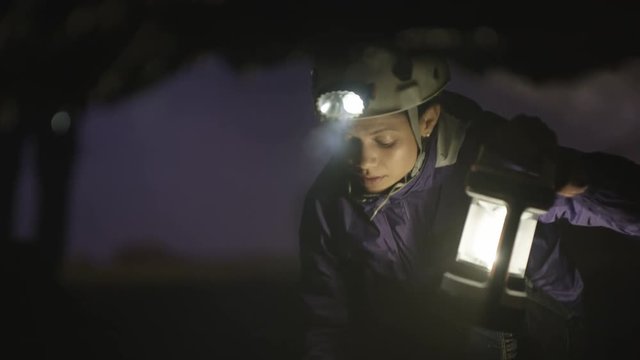  Geologist exploring underground cave, studying rock formation. 