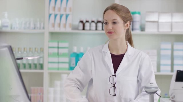  Portrait of friendly smiling worker in a chemist shop
