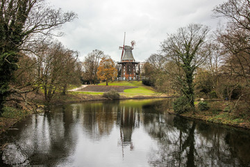 German village scape with wind mill over the lake