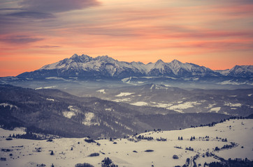 Fototapeta na wymiar Poland, landscape, Tatra mountains under cloudy sky during sunrise, winter