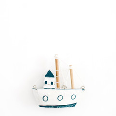 Wooden handmade toy boat on white background. Flat lay, top view