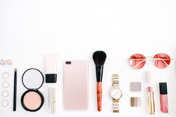 Beauty blog fashion concept. Female pink styled accessories: cell phone, watches, sunglasses,...