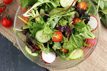 Bowl of salad on wooden table