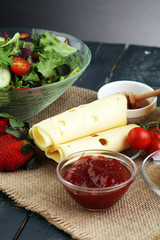 breakfast on table with salad, croissants, coffe and juice