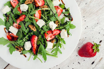 Fresh salad with arugula and strawberries