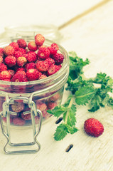 Wild strawberry in glass jar
