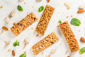 Healthy snack. Fitness. Dietary food. Four cereal granola bars with nuts and fruit berries, with...