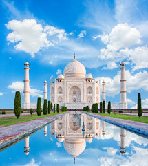 Erstaunliche Aussicht auf das Taj Mahal im Sonnenlicht mit Reflexion im Wasser. Das Taj Mahal ist ein Mausoleum aus elfenbeinweißem Marmor am Südufer des Yamuna-Flusses. Agra, Uttar Pradesh, Indien.