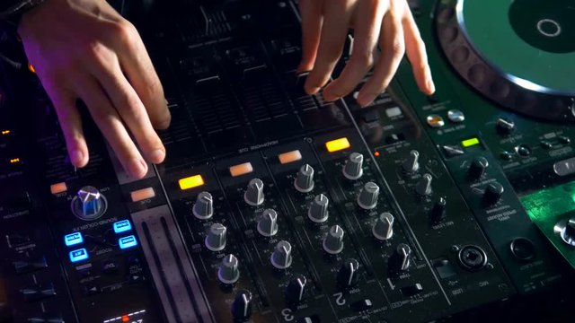 DJ Mixing, Spinning and Scratching in a Night Club party. 4K.