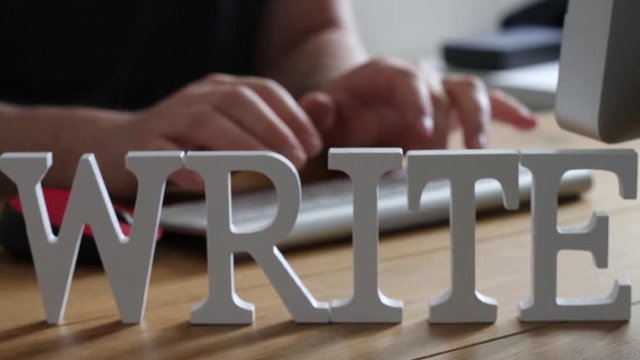Creative writing concept with man typing on keyboard