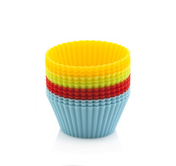 Colourful silicone form for cooking muffin and cupcake on a white background