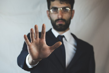 Business man showing stop hand gesture