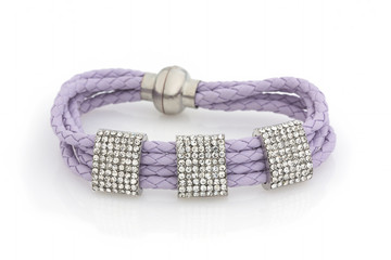 Leather lilac bracelet with rhinestones on a white background. Isolated