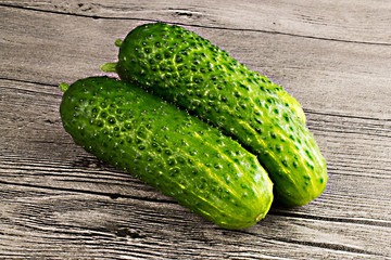 Fresh green cucumbers on wooden table