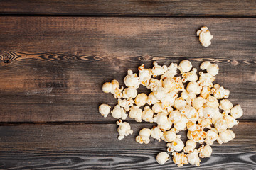 handful of popcorn on a wooden background