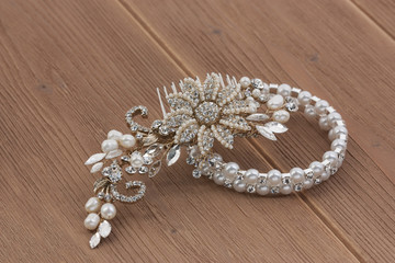 Hair ornament, silver bracelet on a wooden background. Party decorations.