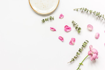 rose, eucalyptus and plates in spring design white background top view mockup