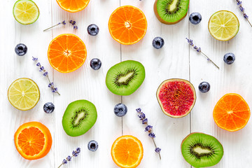 cut fruit design with blueberry and lavender on white background top view pattern