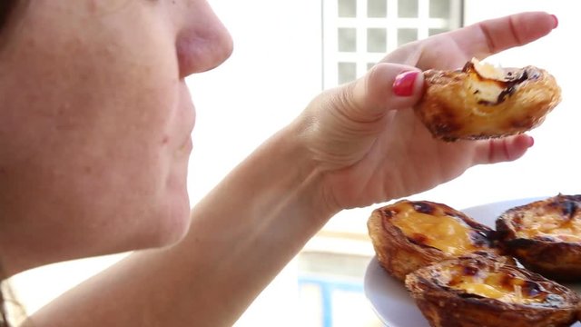 Eating pastry from pastry shop of Belem in Lisbon