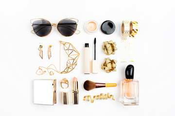 Cosmetics collage with lipstick, brush and other accessories on white background. Composition in gold colors. Flat lay, top view.